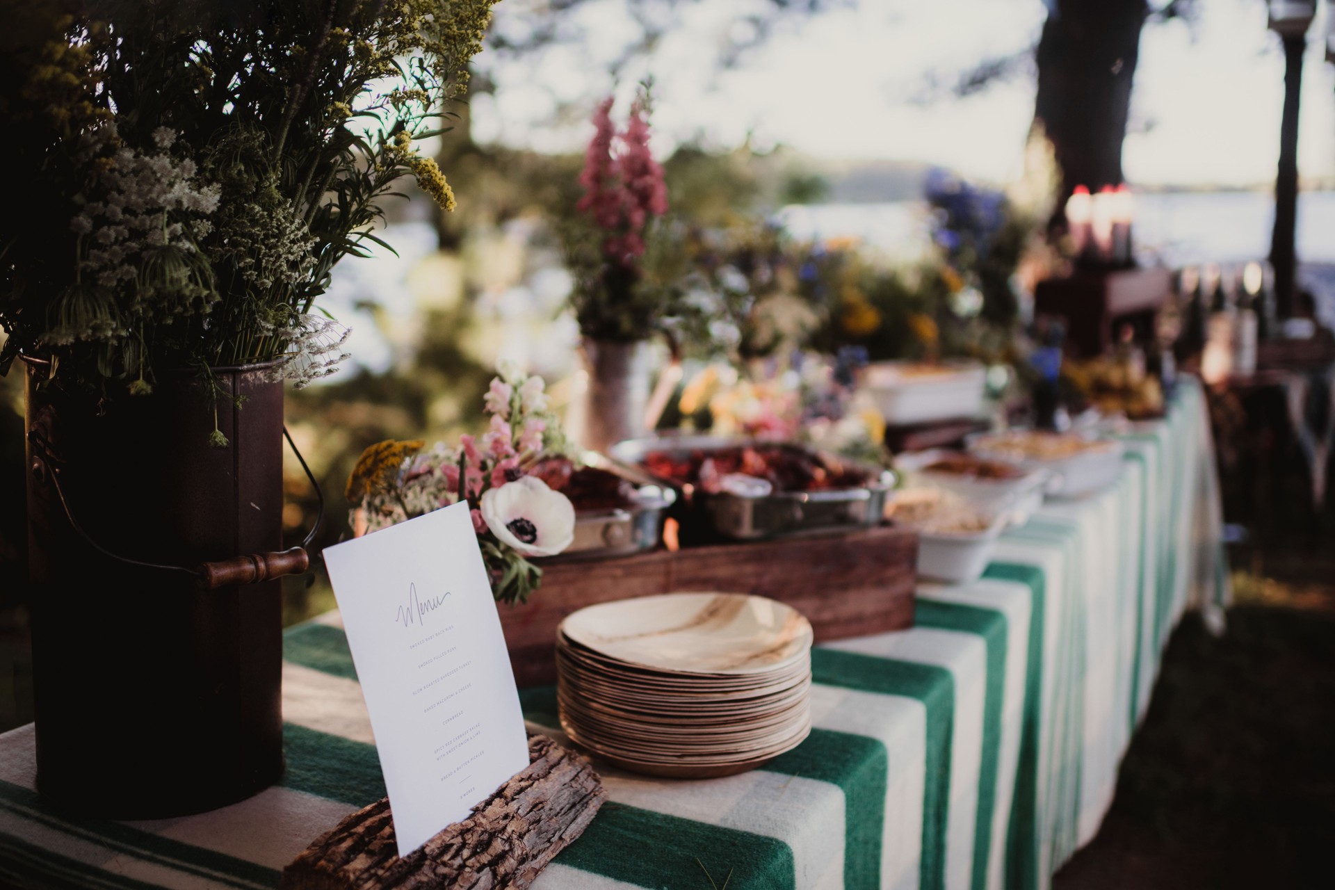 Buffet table set up with menu, flowers food